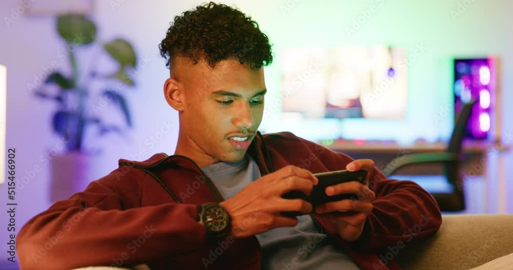 Aufkleber a happy gamer playing on a phone, smiling while relaxing on a sofa. an african american guy streamin