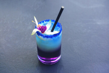 Lavander Fizz, cocktail based on refreshing gin with saffron foam of lavender color on gray background. Summer Color Trends, Attention-grabbing Palettes. 