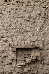 Old ancient cracked wall made of Mud and bricks background and texture pattern.