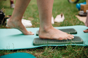 Alternative medicine and mindfulness practice - standing on sadhu board nails barefoot