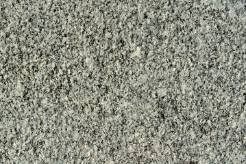 Gray granite texture. Grained stone grunge background. Closeup.