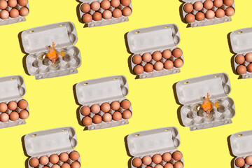 Chicken eggs pattern. top view of Mockup or packaging design, paper box with chicken eggs on a yellow background, eco friendly or green product. Open cardboard box with chicken eggs, broken egg