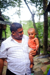 Fototapeta premium Family portrait of south asian cute charming baby boy with his grandfather 