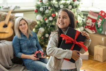 mother and daughter near the Christmas tree