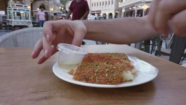 Turkish dessert kunefe, kunafa, kadayif with pistachio powder and cheese, served hot, very sweet