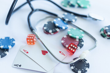 Medical risk concept, stethoscope with poker chip