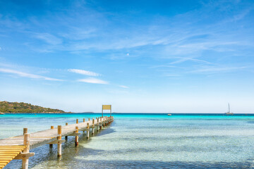 Fototapeta na wymiar Amazing landscape with wooden pier on Santa Giulia beach.