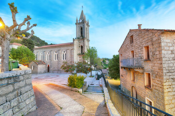 Majestic evening cityscape with Parish Church of the Assumption  in Zonza village