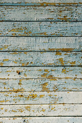 an old wooden background made of boards with peeling paint of vertical