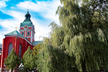 St. Jacob’s Church Peeks from behind Beautiful Weeping Willow Trees in Kungsträdgården Park in Stockholm, Sweden