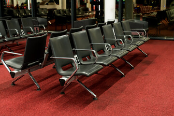 Empty airport terminal waiting area with chairs. airport waiting rooms, lounges with glass windows, chairs and airplanes. Red terminal. Airport. International. 
