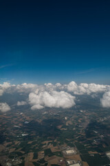 flying and traveling, view from airplane window on the wing. View outside the plane window. Clouds and sky as seen through window of an aircraft. Panorama view of fluffy clouds 