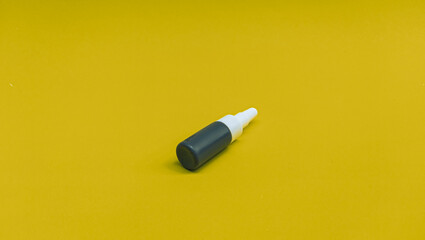 serum cosmetics bottle with yellow background isolated