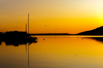 Beautiful Sunrise at Florianopolis with mountains and boats silhouttes at Conceição Lagoon, Santa...