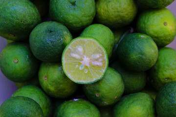 Top view of Lime or Limau (Citrus amblycarpa) slice with a large group of limau background