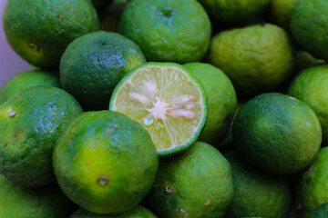 Top view of Lime or Limau (Citrus amblycarpa) slice with a large group of limau background