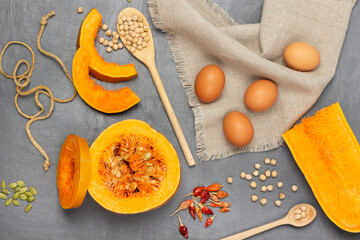 Eggs on napkin. Sliced pumpkin pieces and half pumpkin.
