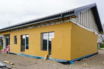 Unfinished modern precast single storey private house with gray metal roof