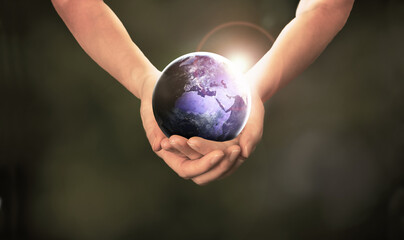 Earth at night in hands on dark background, Earth day, The World need Help and care right now concept, Elements of this image furnished by NASA