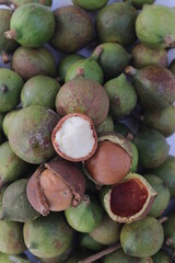 Raw macadamia nuts isolated on white backgroun