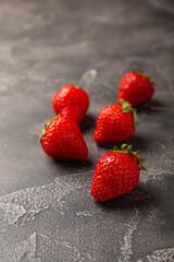 Fresh ripe strawberry on black texture background.Vegetarian organic berry.Healthy food.Copy space.Place for text