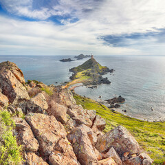Popular tourist destination Torra di a Parata with Genoese Tower and Archipelago of Sanguinaires islands at background.