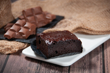 Chocolate Brownie Served in a dish side view on grey background