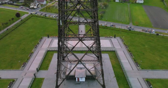 Aerial view of the wooden broadcasting tower in Gliwice with the city of Gliwice in the background. The concept of the largest wooden tower in the world. Wooden construction from a drone.