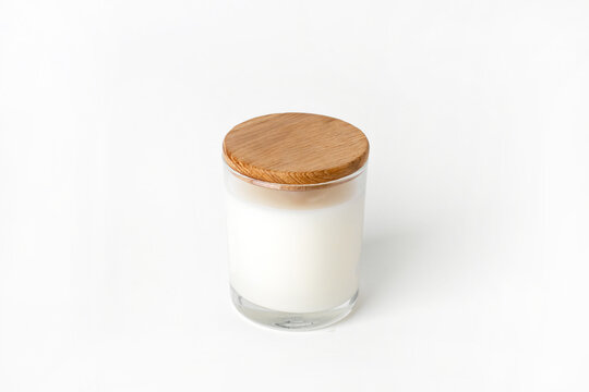 Soy candles in glass cans, handmade modern hobby , harmless coconut wax candles without paraffin with wood on white background isolated