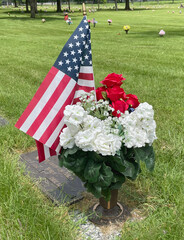 Cemetery Memorial Day flags and flowers in an urn, 2022. - 515493744