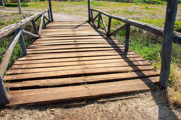small wooden bridge over creek in lake park