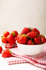 Fresh ripe strawberries in a plate on a white wooden background.Vegetarian organic berry.Healthy food.Vitamins.Copy space.Space for text