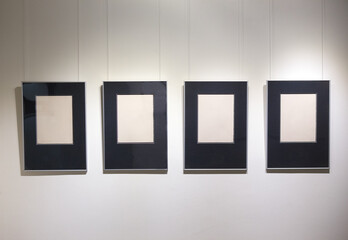Picture frames in a row on a white wall