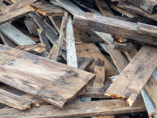 A pile of broken old boards. Lots of wood pieces. Old rotting sticks. Rubbish