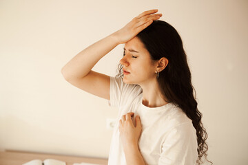 Sad woman with migraine strong headache disease. Depression. Overstressed woman with head pain touches head.