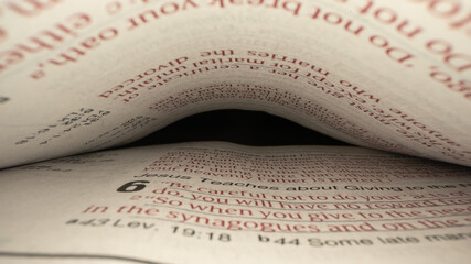 A macro probe lens shot in between the pages of the bible.