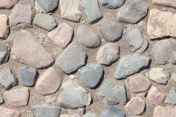 Photo-texture of a pavement paved with rough untreated stones