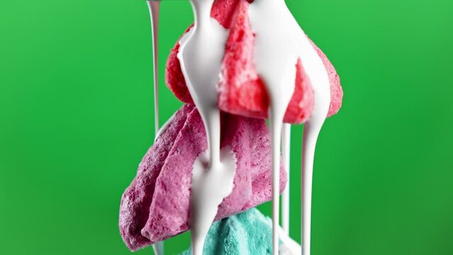 Colorful little bizet. Stock footage.A small neat crunchy cookie on a green background that stands on top of each other and which is poured with sugar syrup