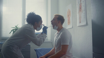 Nurse taking saliva sample from patient. Woman doctor collecting tests covid19.