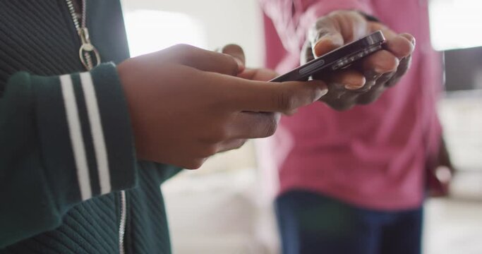 Video of hands of nervous african american father taking his son smartphone and arguing in kitchen