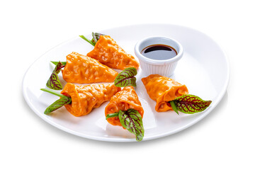 Manti with carrots and pumpkin. On a white background in a plate. Vegetarian dish. Isolated