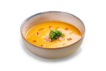 Pumpkin cream soup with shrimp. On a white background, isolated.