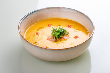Pumpkin cream soup with shrimp. On a white background, isolated.