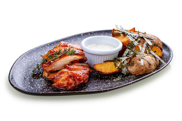Chicken in Teriyaki sauce with roasted potatoes.In peel and garlic sauce. On a white background, isolated.