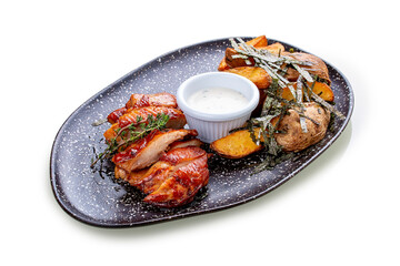 Chicken in Teriyaki sauce with roasted potatoes.In peel and garlic sauce. On a white background, isolated.