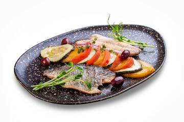 Sea bass fillet with vegetables ratatouille . On white background, isolated.