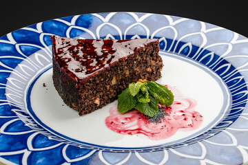 Poppy and apple pie with nuts. On a dark background, isolated.