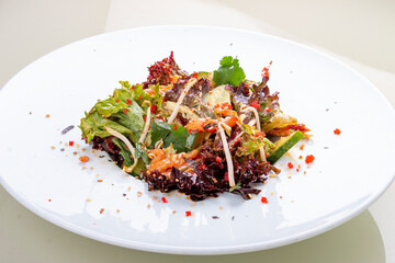 Salad with crispy salmon belly and flying fish roe. On a white background, isolated.