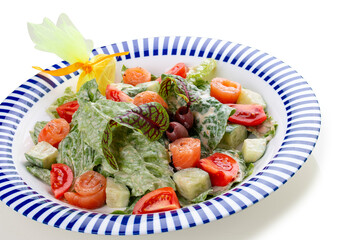 Caesar salad with lightly salted salmon, Romano salad, with blue cheese sauce. On a white background, isolated.