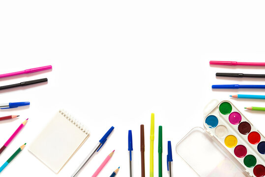 school stationery with markers and other supplies on white background. back to school concept